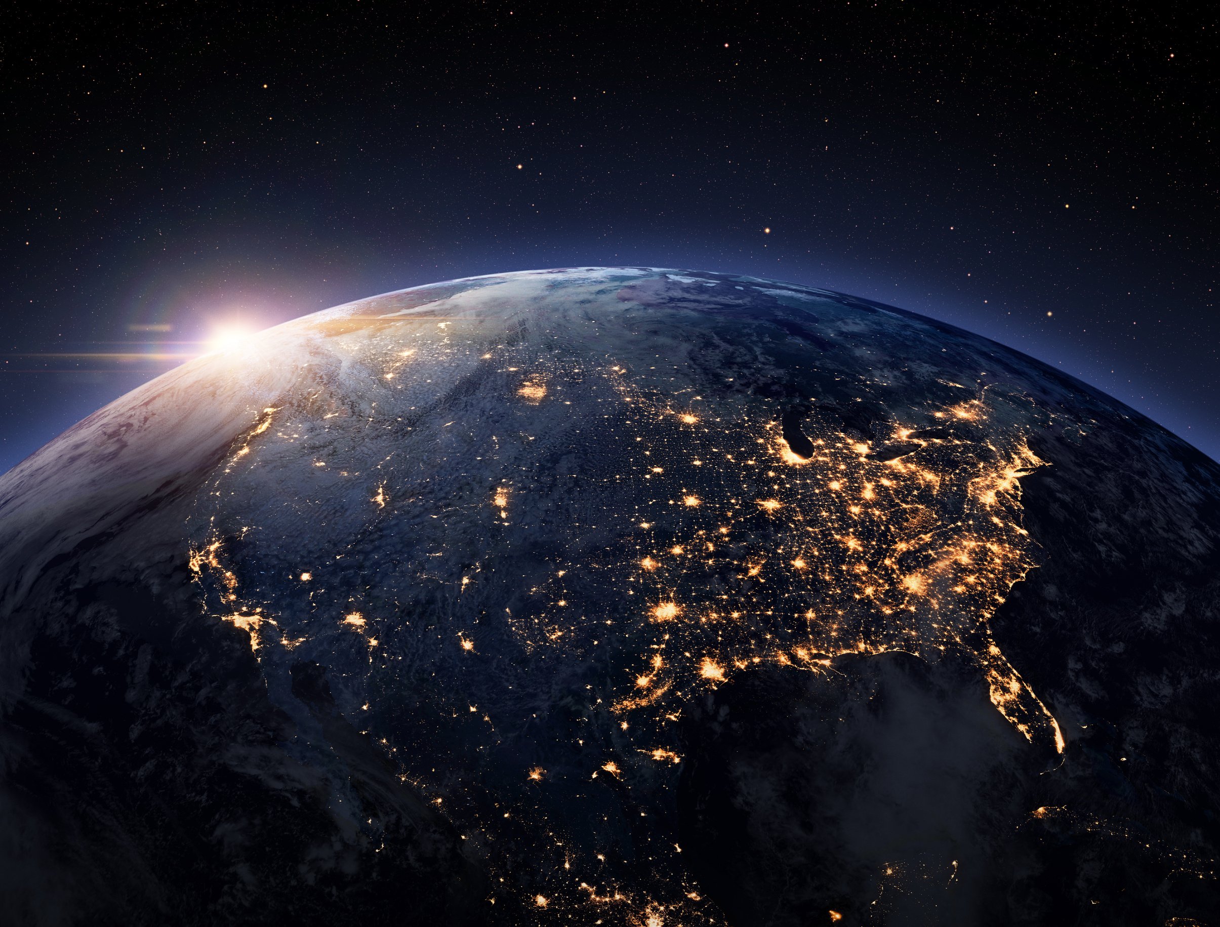 View of earth from space, featuring city lights across the United States, representing the connection between AIYSpace and the vast, interconnected world we support and inspire.