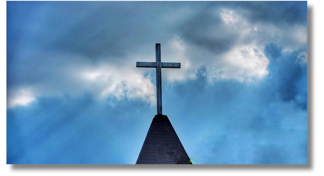 A photo of a cross standing tall against the sky, symbolizing the religious organizations that Astronauts in Your Space serves. The cross represents the faith-based route, emphasizing spiritual guidance and devotion central to the AIYSpace mission.